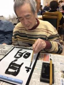 サービス付き高齢者向け住宅で利用者さんの年始書初め「月明り」　善幸苑